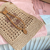 WANDER BUCKET BAG 23 IN NATURAL RAFFIA WITH LEATHER TRIM