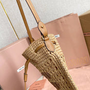 WANDER BUCKET BAG 23 IN NATURAL RAFFIA WITH LEATHER TRIM