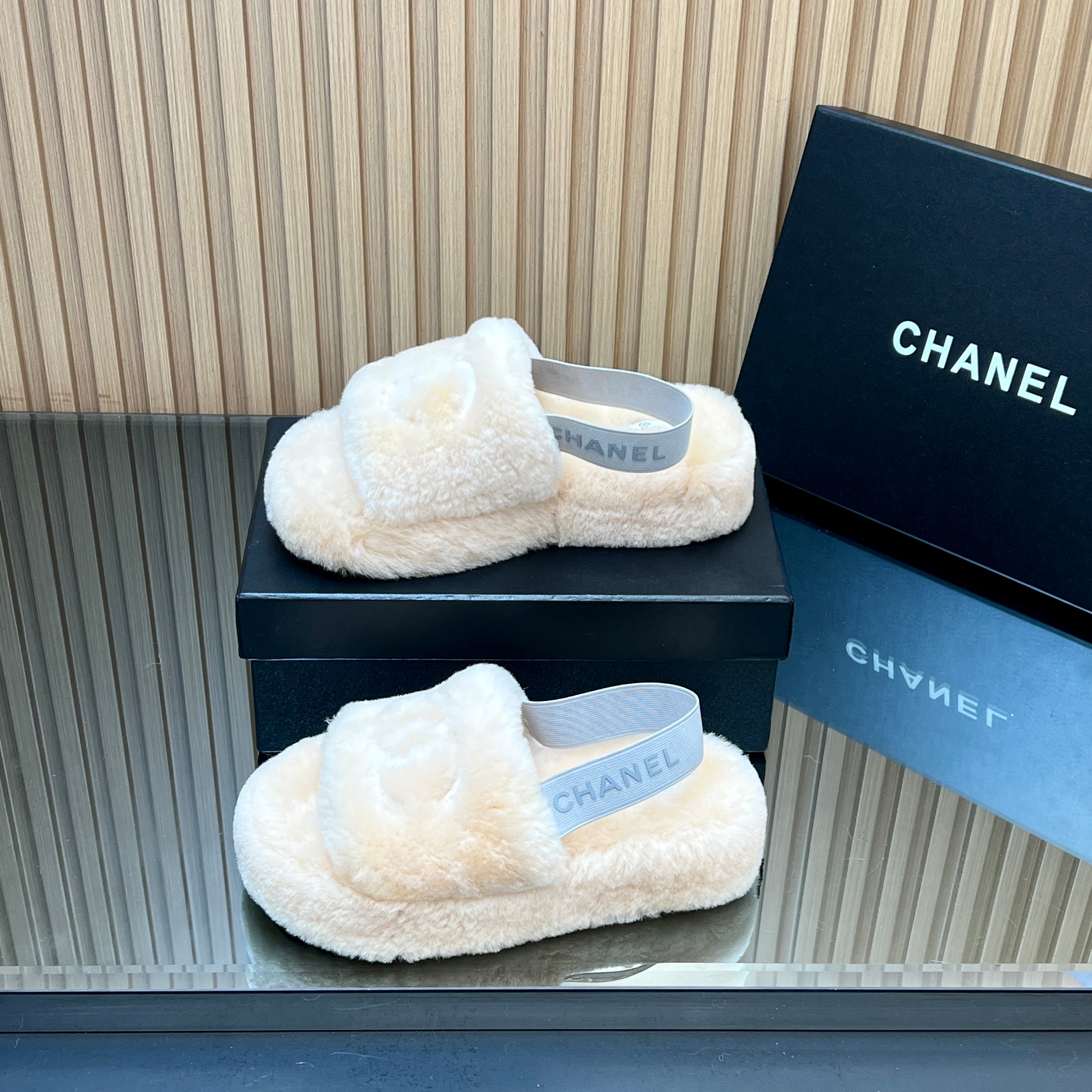 CHANEL 25S THICK-SOLED FURRY SLIPPERS WITH ELASTIC STRAPS IN BEIGE FUR