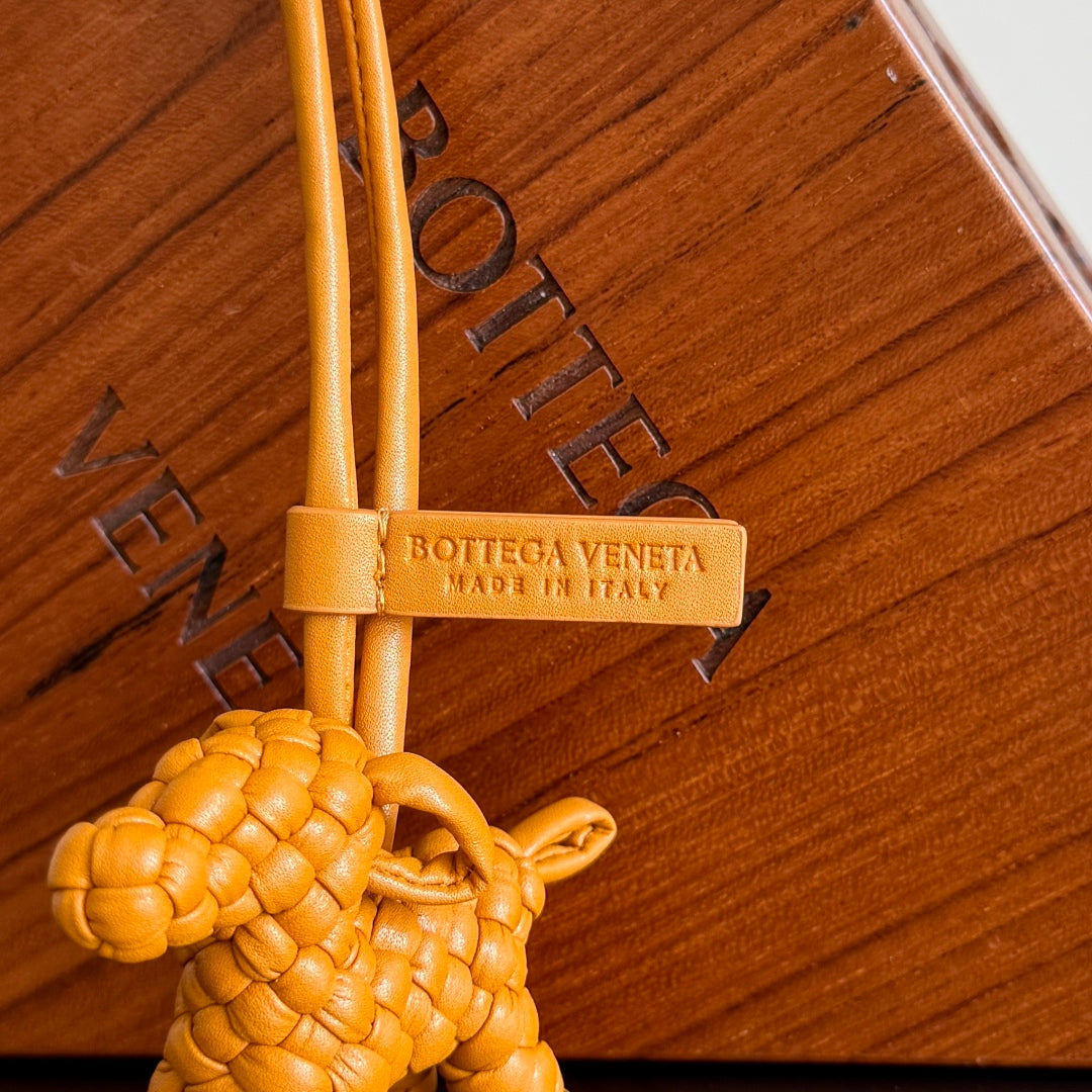 BOTTEGA VENETA 25S DOG CHARM IN BURNT ORANGE CALFSKIN