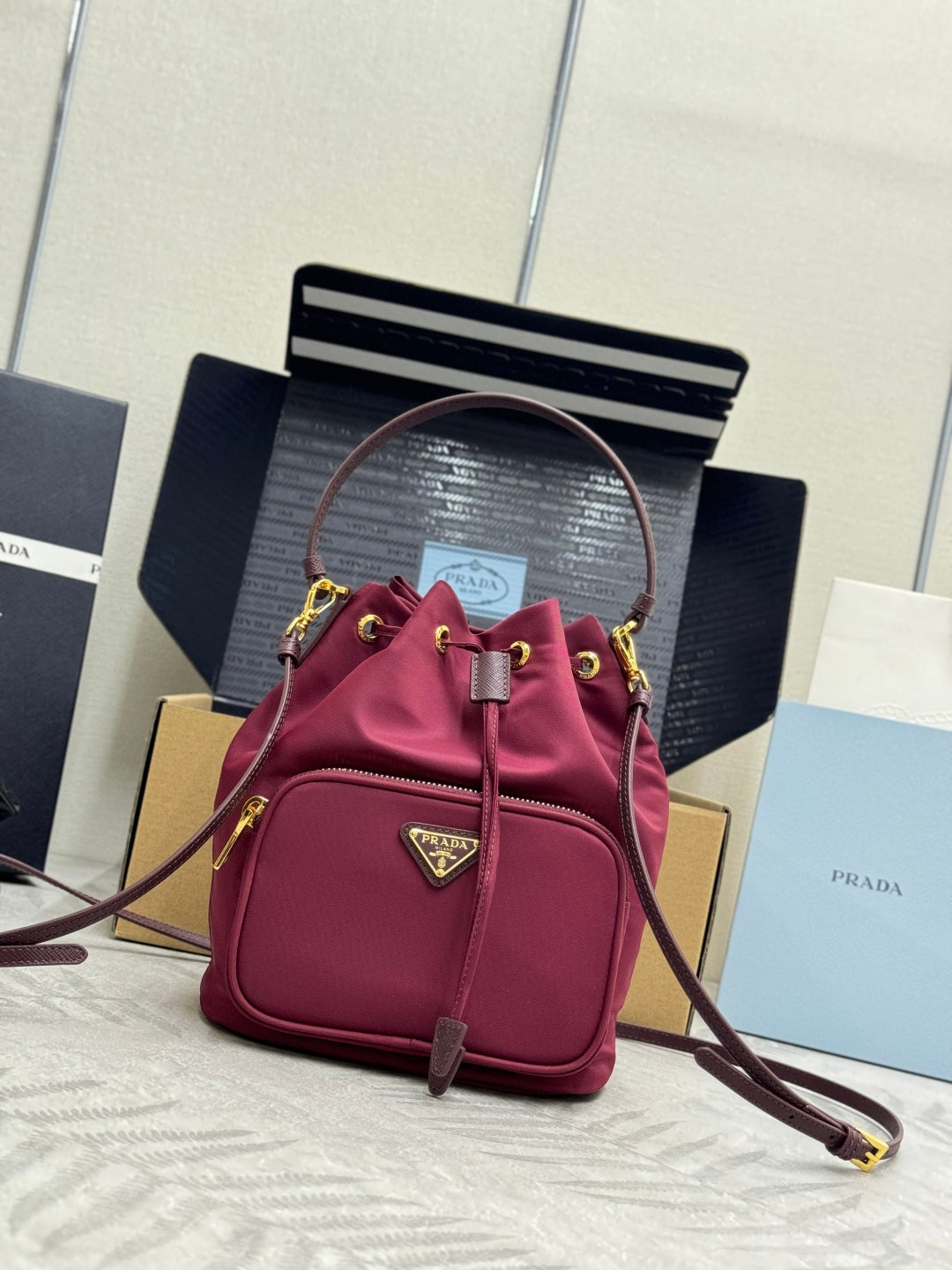 PRADA 25S DUET BUCKET BAG 23 IN BURGUNDY RE-NYLON GOLD HARDWARE