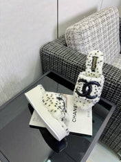 CHANEL 26S PLATFORM SLIDE SANDALS IN WHITE SHEARLING AND BLACK CC LOGO SQUARE TOE