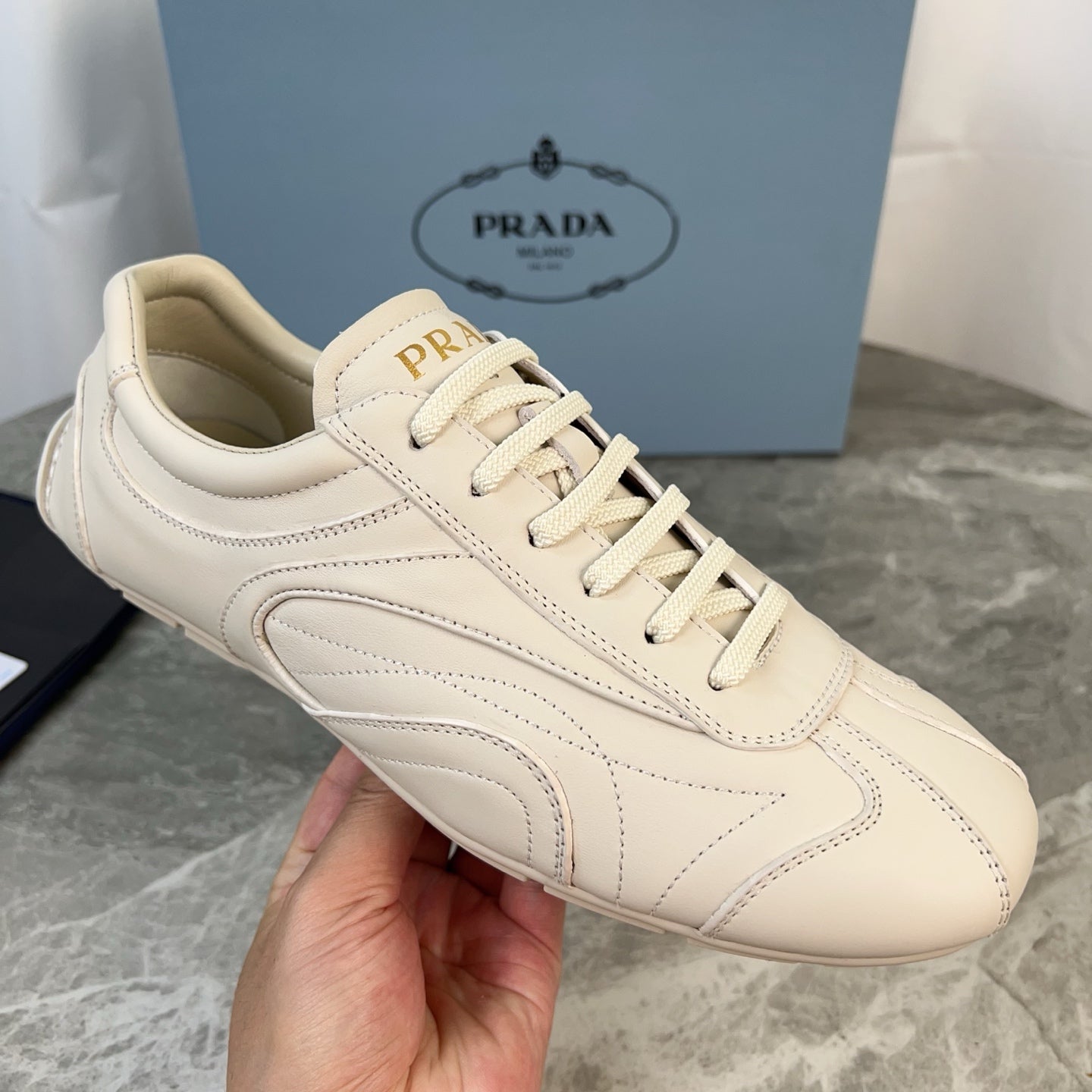 PRADA 25S MONTECARLO ANTIQUED SNEAKERS IN CHALK WHITE NAPPA LEATHER
