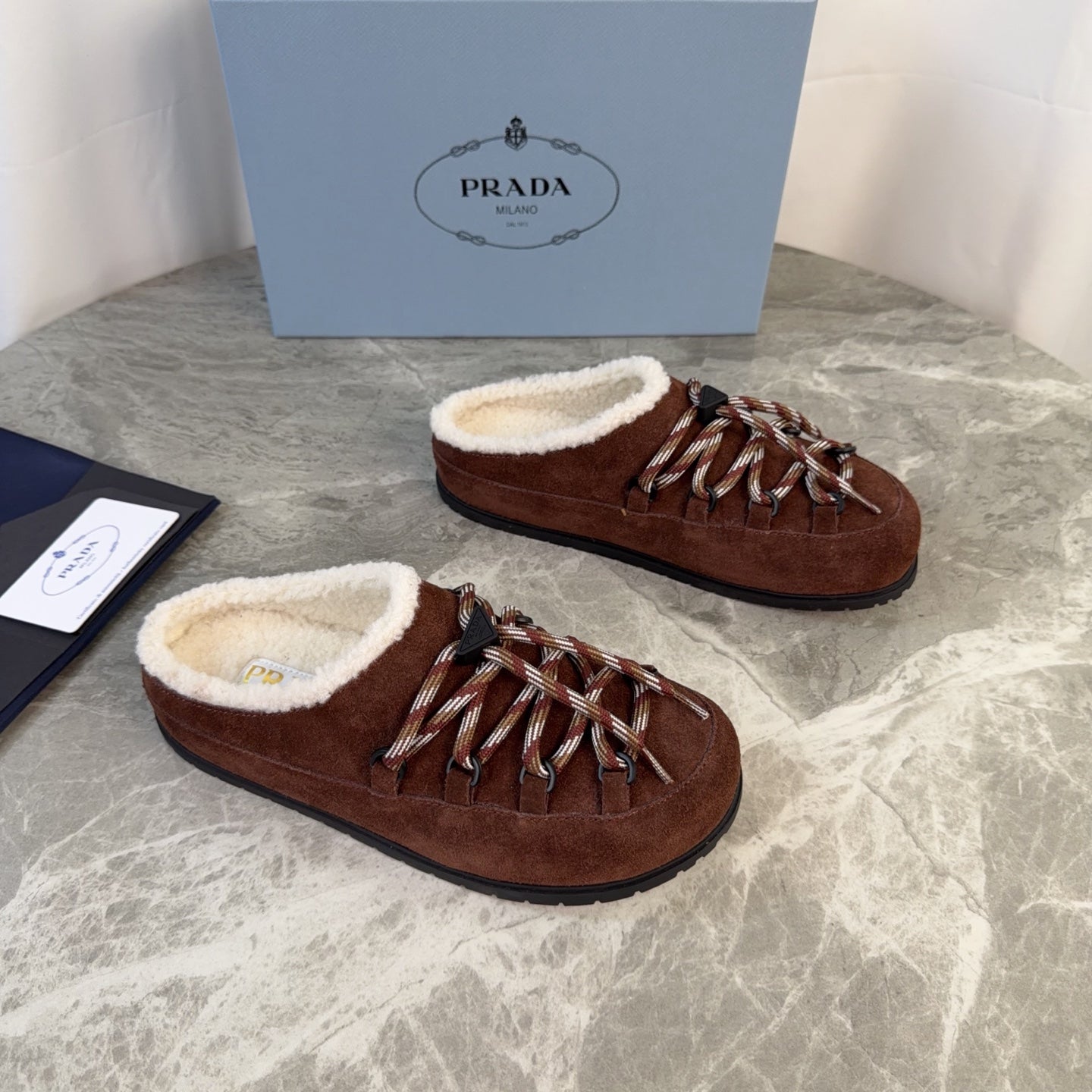 PRADA 26S WOVEN MULES IN DARK BROWN SUEDE
