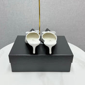 CC HEEL MULES 25S IN BLACK AND WHITE LAMBSKIN WITH BOW