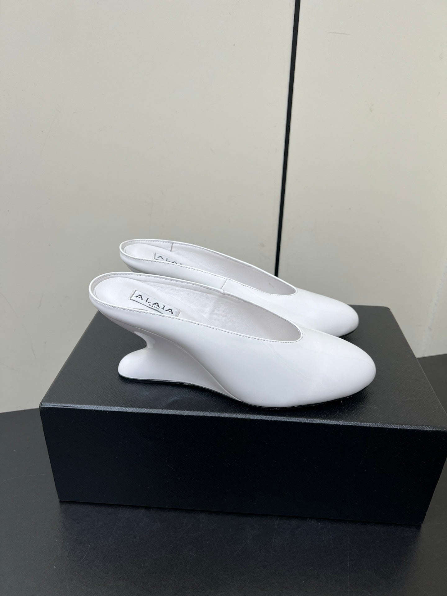ALAIA WEDGE MULES 25S IN CREAM WHITE LAMBSKIN