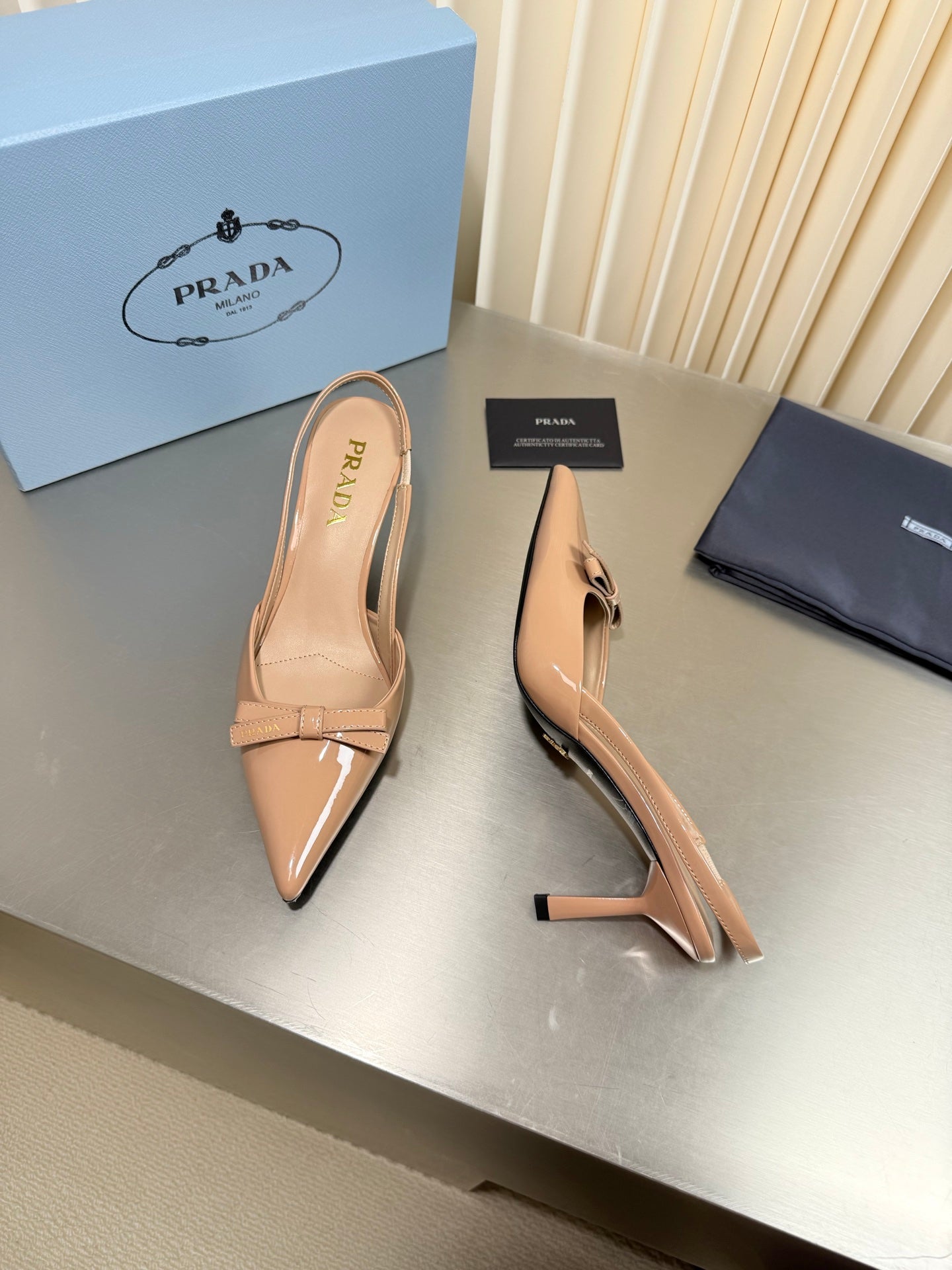 PRADA 26S POINTED-TOE SLINGBACK PUMPS IN BEIGE PATENT CALFSKIN WITH BOW