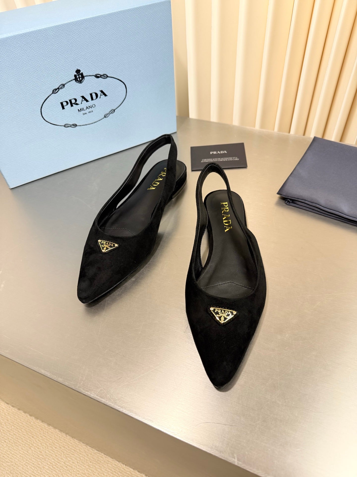PRADA 26S SLINGBACK FLATS IN BLACK SUEDE WITH GOLD HARDWARE