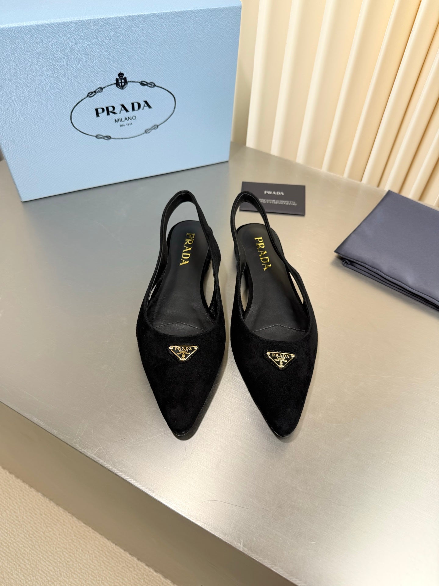 PRADA 26S SLINGBACK FLATS IN BLACK SUEDE WITH GOLD HARDWARE
