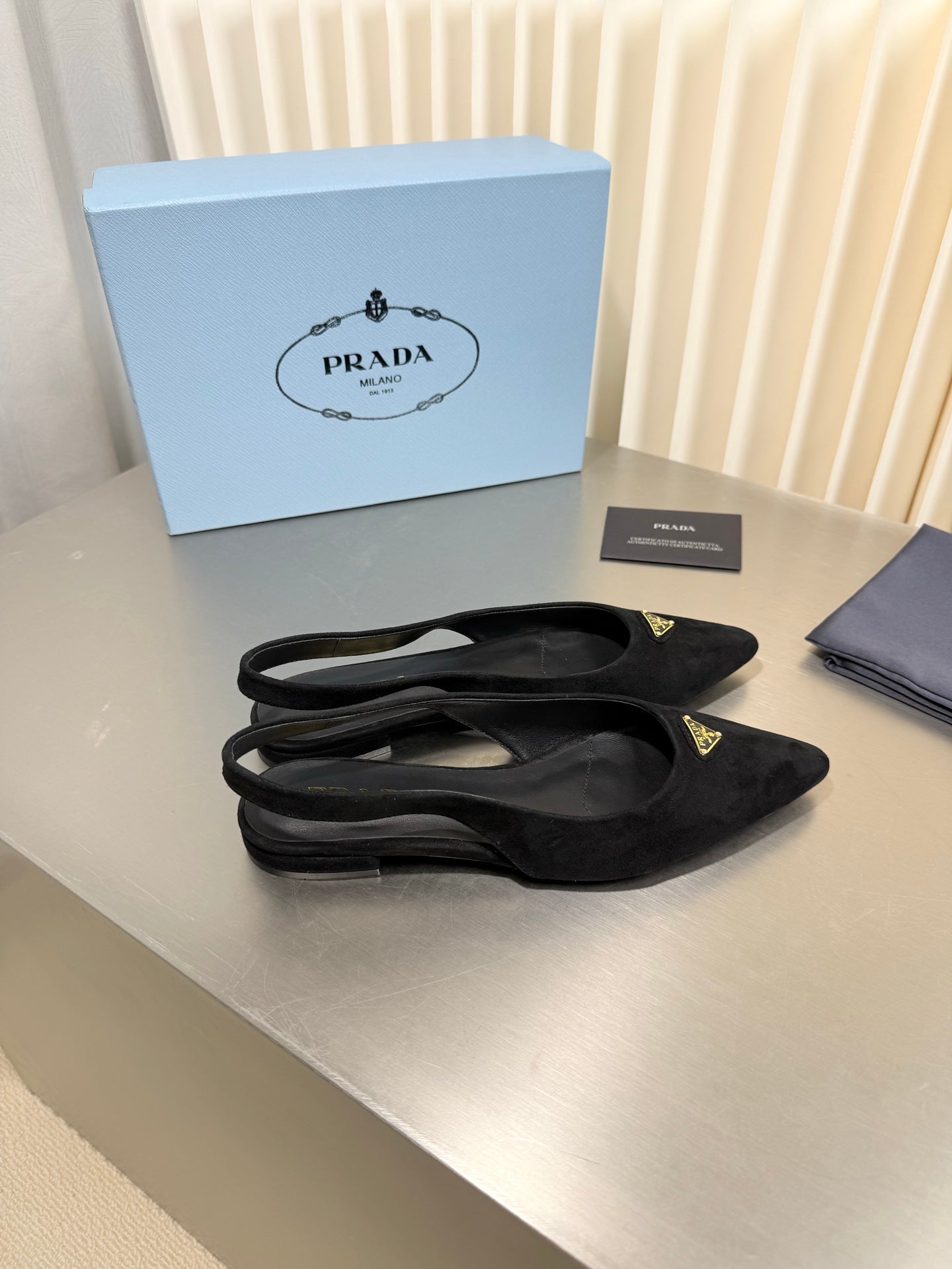 PRADA 26S SLINGBACK FLATS IN BLACK SUEDE WITH GOLD HARDWARE
