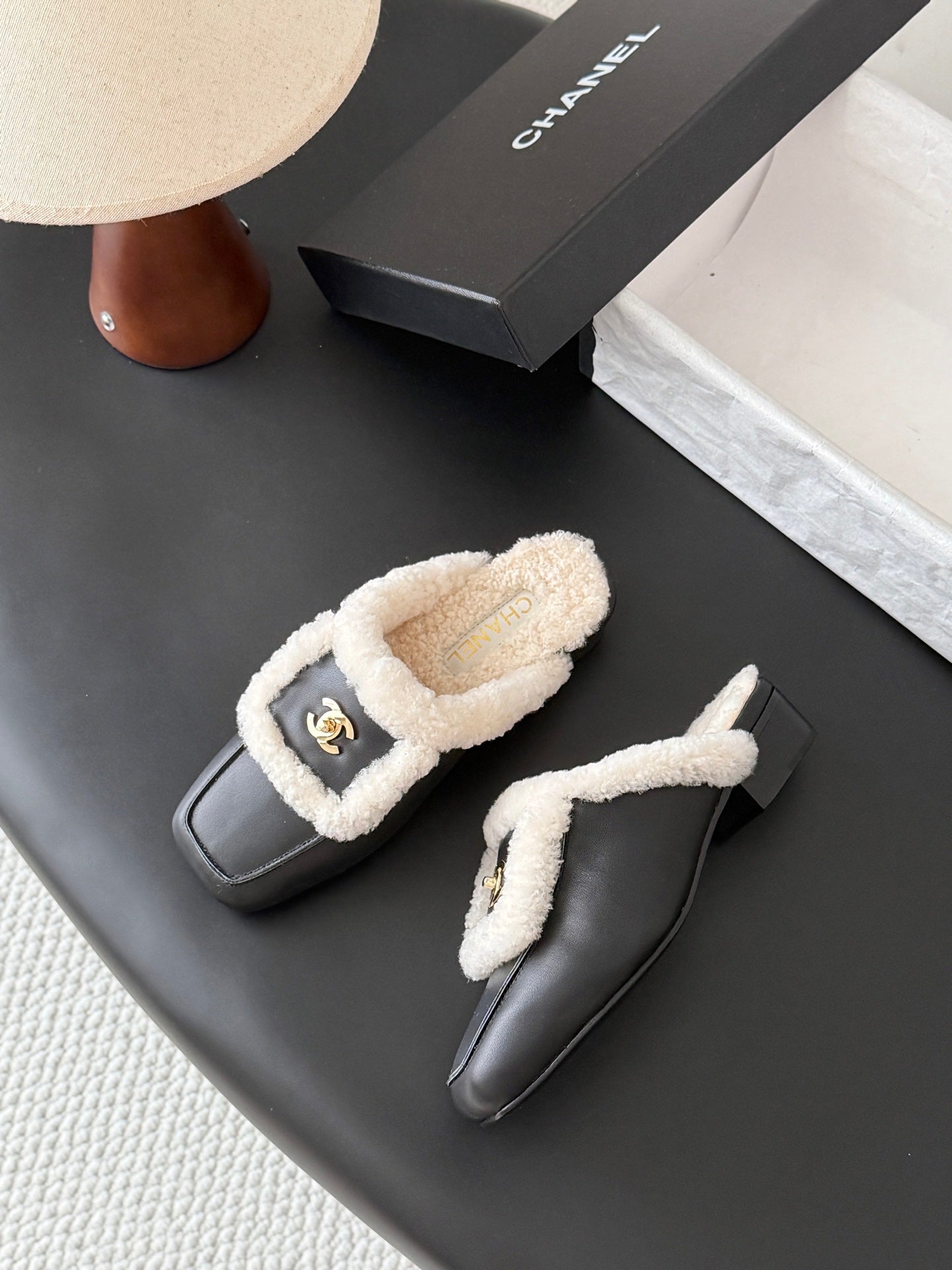 CHANEL 26S MULES IN BLACK SHEARLING AND CALFSKIN