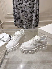 PRADA 26S GEAR SOLE SNEAKERS IN WHITE SUEDE AND MESH