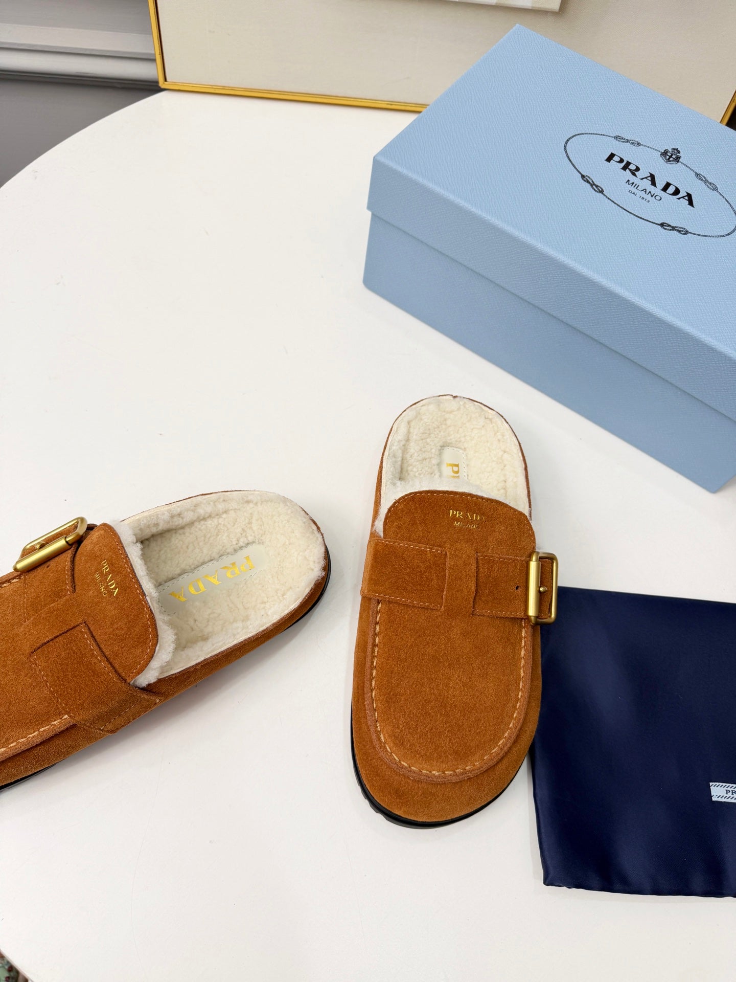 PRADA 26S SHEARLING-LINED MULES IN COGNAC BROWN SUEDE